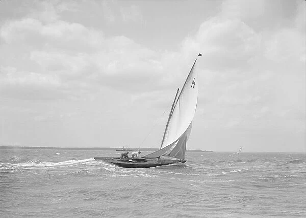 The 6 Metre class Ejnar sailing downwind, 1911. Creator: Kirk & Sons of Cowes