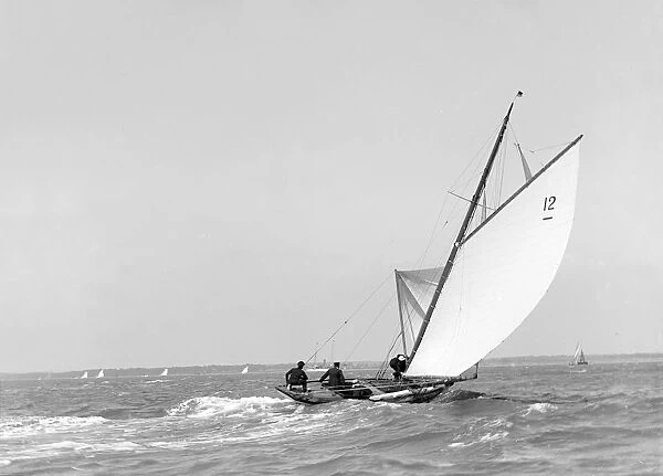 The 8 Metre sailing yacht Dilkusha setting spinnaker, 1911. Creator: Kirk & Sons of Cowes
