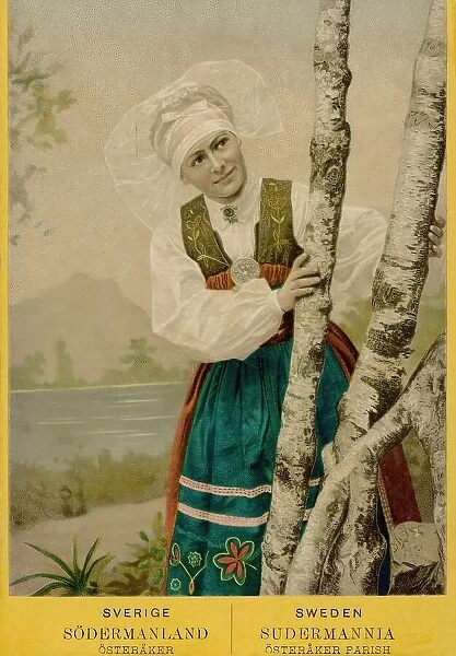 Coloured portrait photograph of a woman looking out from behind birch trunks, 1870-1900. Creator: Unknown