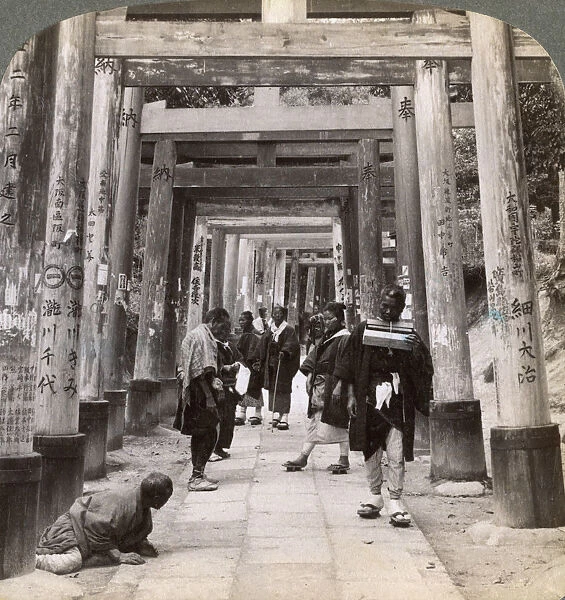 Coming and going under long rows of sacred torii, Shinto temple of Inari, Kyoto, Japan, 1904. Artist: Underwood & Underwood