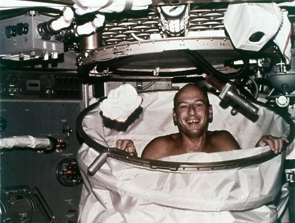 Conrad in shower facility aboard Skylab 2, 1973. Creator: NASA