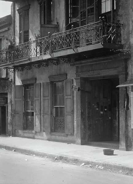 Facades of buildings along a street in the French Quarter, New Orleans, between 1920 and 1926. Creator: Arnold Genthe