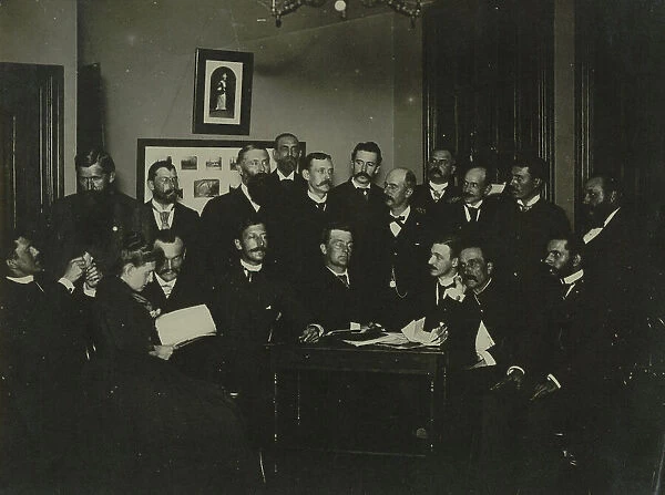 Frances Benjamin Johnston, seated in profile at left, group portrait with 18... c1880 - 1900. Creator: Frances Benjamin Johnston