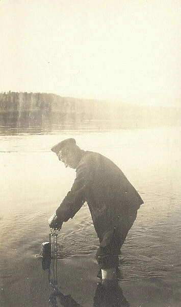 The moment of measuring the water level at the Inorogda hydrometric station, 1909. Creator: Vladimir Ivanovich Fedorov