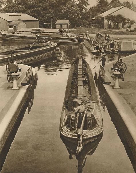 Pushing a Monkey Boat Through The Lock at Brentford, c1935. Creator: Unknown