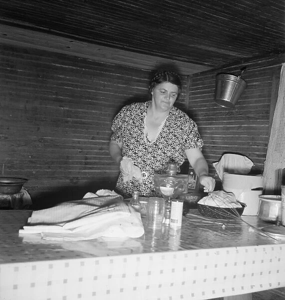 Tobacco sharecroppers wife cleaning up table after washing... Person County, North Carolina, 1939. Creator: Dorothea Lange