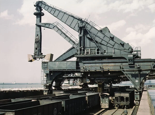 Unloading a lake freighter at the Pennsylvania Railroad iron ore docks... Cleveland, Ohio, 1943. Creator: Jack Delano