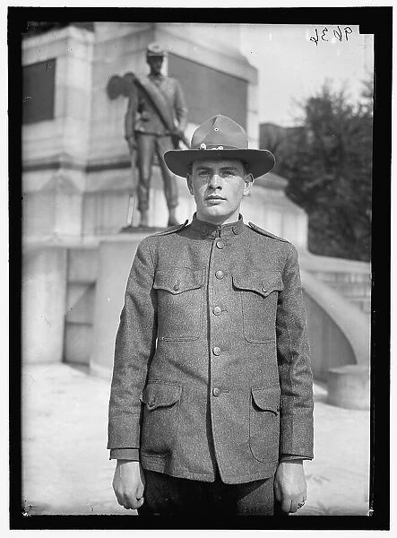 Young man in uniform standing in front of Sherman Monument, Washington, D.C. between 1916 and 1918. Creator: Harris & Ewing. Young man in uniform standing in front of Sherman Monument, Washington, D.C. between 1916 and 1918