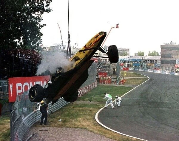 1997 CANADIAN GP. Ralf Schumachers wrecked car is lifted away after a massive crash