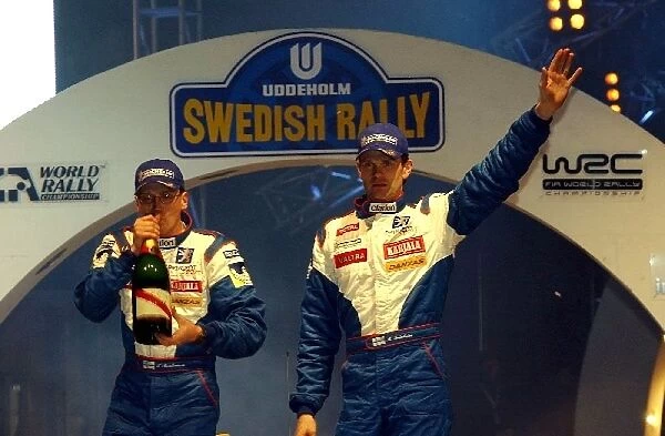 FIA World Rally Championship: Rally winner Marcus Gronholm, right, and Timo Rautiainen, Peugeot, on the podium
