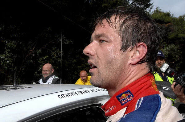 FIA World Rally Championship: Sebastien Loeb Citroen checks the stage times to see his final position. Looking somewhat hot