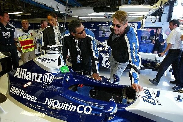 Formula One World Championship: Actor Laurence Fishbourne and actor Jeremy Irons in the Williams garage