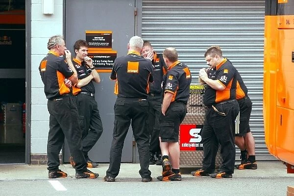 Formula One World Championship: Arrows mechanics loiter the paddock waiting to see if the cars will turn up to race