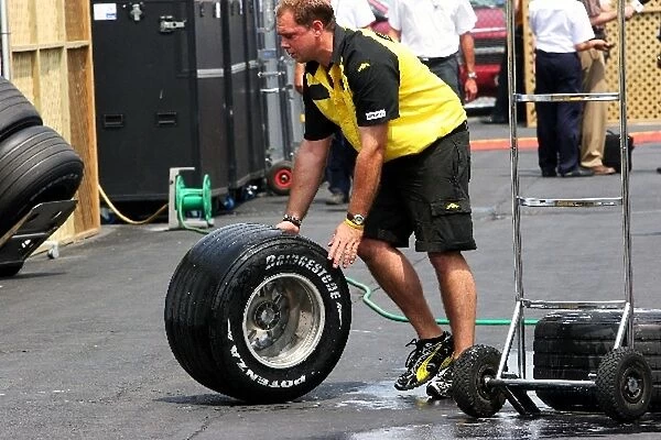 Formula One World Championship: Bridgestone tyre washing by a Jordan mechanic