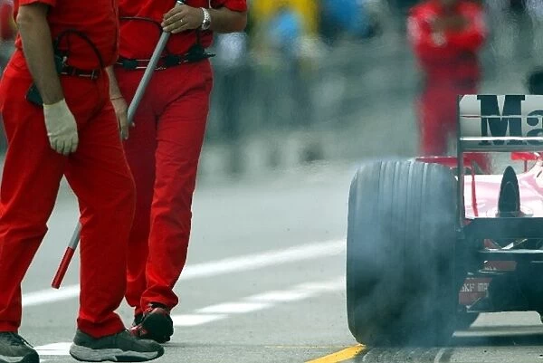 Formula One World Championship: A Ferrari F2002 lays down rubber in the pitlane