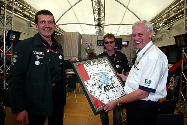 Formula One World Championship: Guenther Steiner Jaguar Technical Director presents a signed print to Rick Parfitt HP
