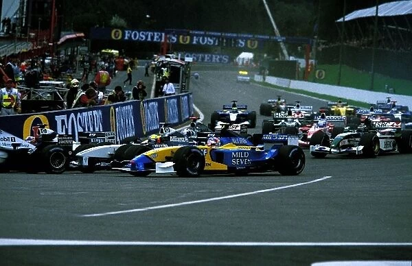 Formula One World Championship: Jarno Trulli Renault R202 goes around the outside of the field at La Source at the start of the race