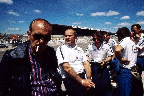 Formula One World Championship: The Ligier team stand by the pit wall including Guy Ligier and Gerard Ducarouge Ligier Team Manager and Designer