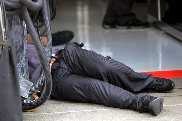 Formula One World Championship: Mobil refueling equipment attacks a McLaren mechanic