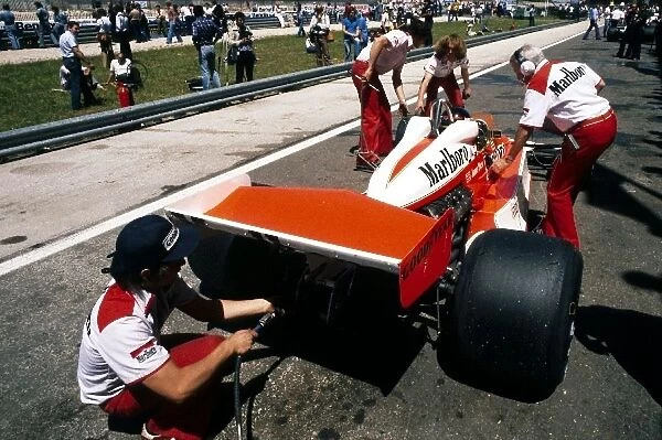Formula One World Championship: Third placed James Hunt has his McLaren M26 fired up in the pit lane during practice