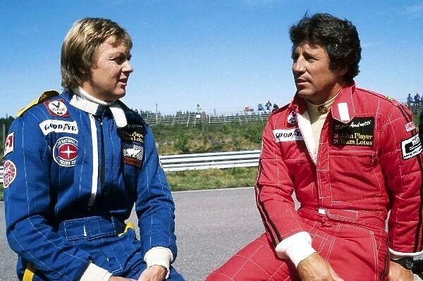 Formula One World Championship: Third placed Ronnie Peterson talks with his Lotus team mate Mario Andretti, who was battling for the lead of