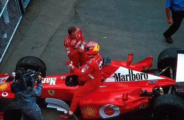 Formula One World Championship: Third placed Rubens Barrichello congratulates his team mate Michael Schumacher on his sixth victory of the season