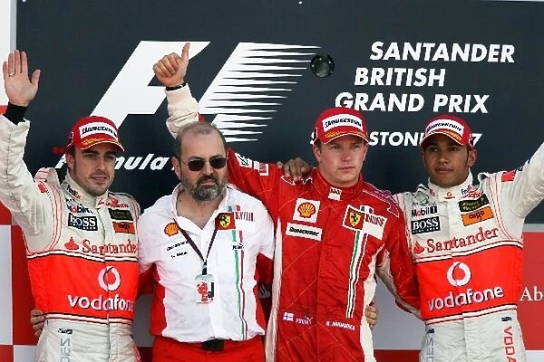 Formula One World Championship: The podium: Fernando Alonso McLaren, second; Gilles Simon Ferrari Engine Department; Kimi Raikkonen Ferrari