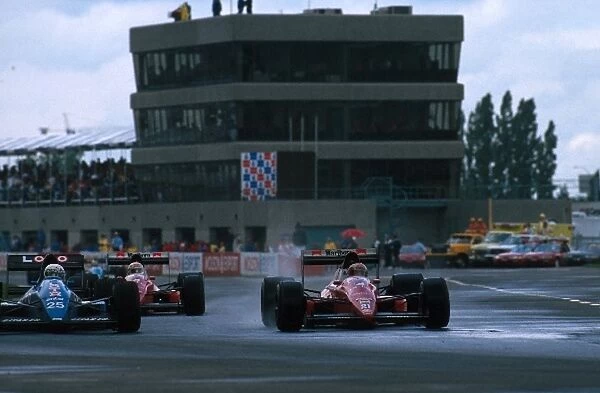 Formula One World Championship: Rene Arnoux Ligier JS22 and Alex Caffi Dallara F189 battle it out in the wet conditions