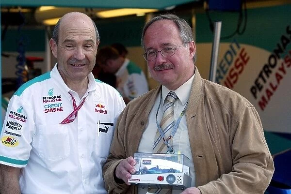 Formula One World Championship: Samuel Schmid Haed of Federal Department of Defence, Sport and Swiss Confederation is presented with a signed