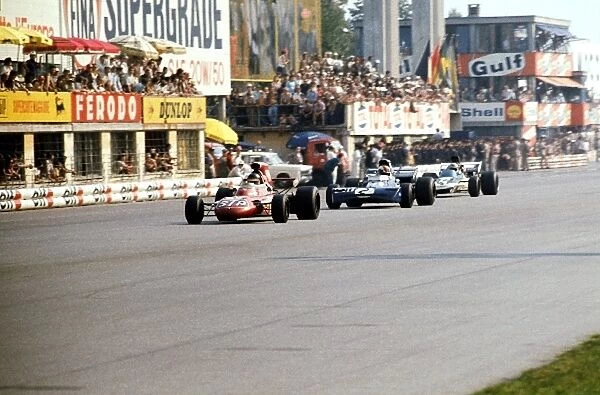 Formula One World Championship: Second placed Ronnie Peterson March 711 leads third placed Francois Cevert Tyrrell 002 and Mike Hailwood Surtees
