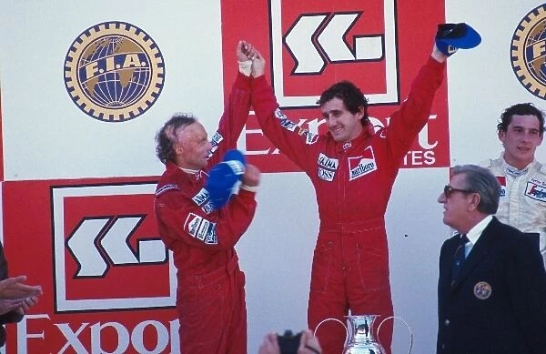 Formula One World Championship: winner Alain Prost, centre, with second place Niki Lauda, left, and third place Ayrton Senna, right
