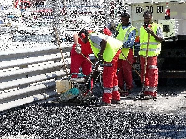 Formula One World Championship: Workmen resurface a section of the track