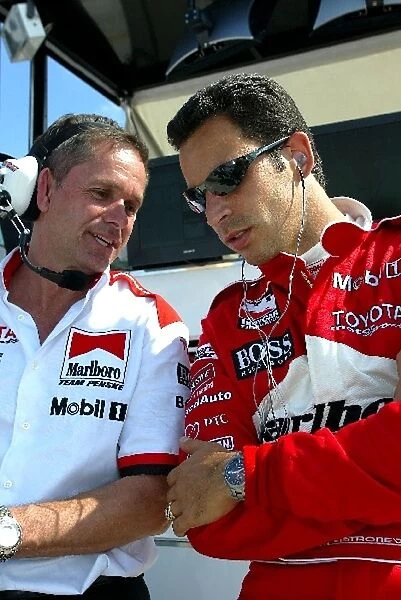 Indy Racing League: Helio Castroneves, right, Team Penske, talks with his crew chief after practice for the Toyota Indy 300