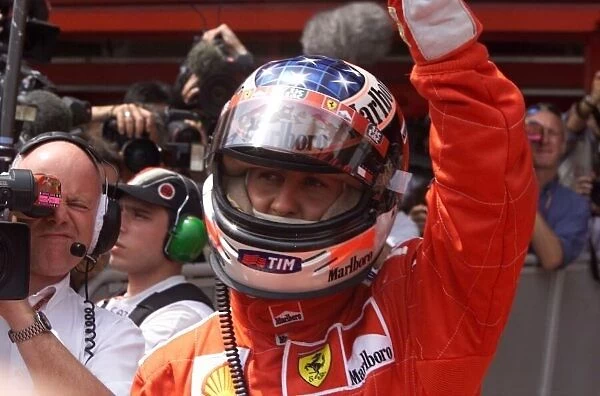 Michael Schumacher celebrates getting pole position