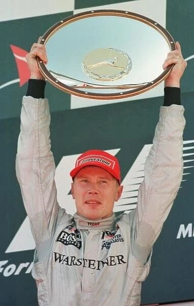 SE 4. Mika Hakkinen celebrates after winning the Australian Grand Prix