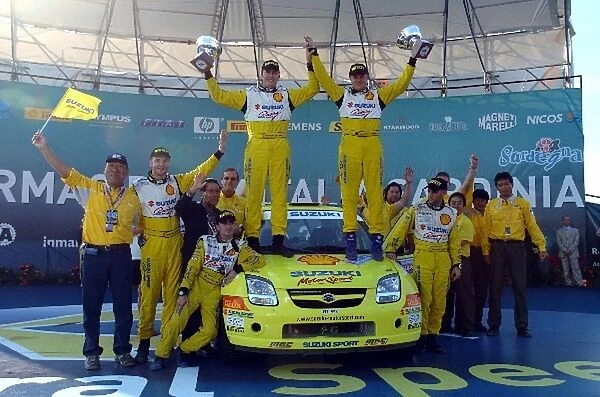 World Rally Championship: Per-Gunnar Andersson, winner of the JWRC category on the podium with 2nd placed Guy Wilks, 3rd placed Mirco Baldacci