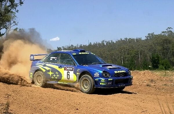 World Rally Championship: Petter Solberg Subaru Impreza WRC kicks up the dirt on stage 2. Day one