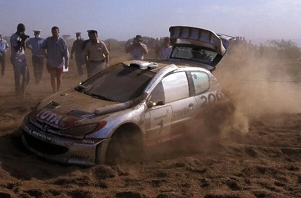 World Rally Championship: Richard Burns was forced to retire when his 3-wheeled Peugeot 206 WRC becmae stranded in deep sand metres
