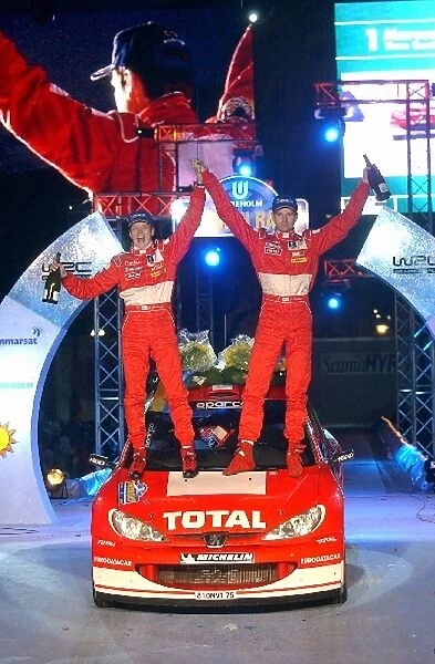 World Rally Championship: Timo Rautiainen Peugeot and Marcus Gronholm Peugeot celebrate their victory in a Peugeot 206 WRC