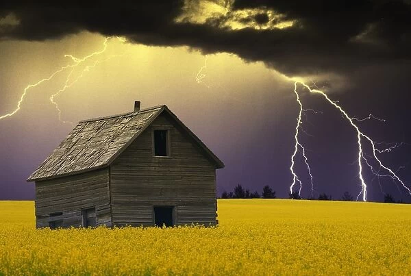 An Abandoned Farm Building With Lighting In The Background