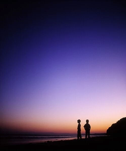 Achill Island, Co Mayo, Ireland; Silhouette Of Children Standing On The Beach Near The Atlantic