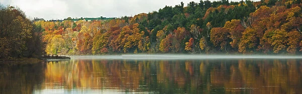 Autumn Coloured Trees Along The Shoreline Of A Lake; Maine United States Of America
