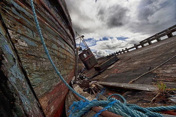 A Blue Rope Tied To An Old Weathered Wooden Boat On A
