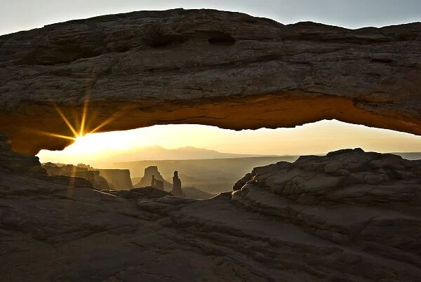 Canyonlands National Park, Utah, Usa; Sunset Through Arch Of Rock Formation