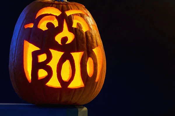 Carved Pumpkin Glowing With The Word Boo Carved In Mouth; Calgary, Alberta, Canada