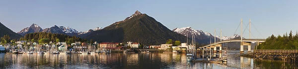 Downtown Sitka And The O connell Bridge On A Clear Summer Evening, Sitka Harbour And Docked Fishing Boats In The Foreground, The Sisters Mountains With Snow On The Peaks In The Background; Sitka, Alaska, United States Of America