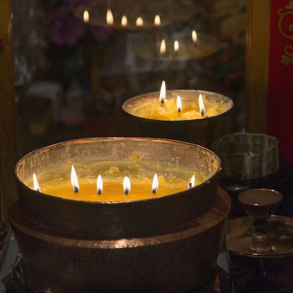 Flames burning in a row in large bronze pots; Lhasa xizang china