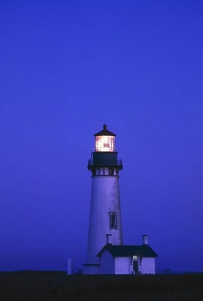 Illuminated Yaquina Head Lighthouse At Dawn