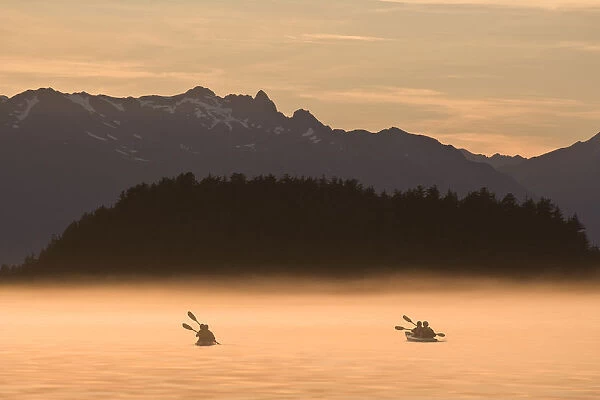 Kayakers Paddling Through The Misty Waters Of Favorite Passage, Near Sentinel Island. Summer In Southeast Alaska