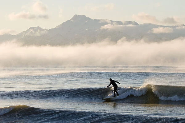 Man Surfing In Moring Near Homer Kachemak Bay W  /  Kenai Mountains Kenai Peninsula Alaska Winter